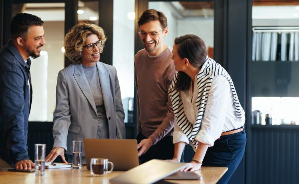 Happy people standing at a meeting