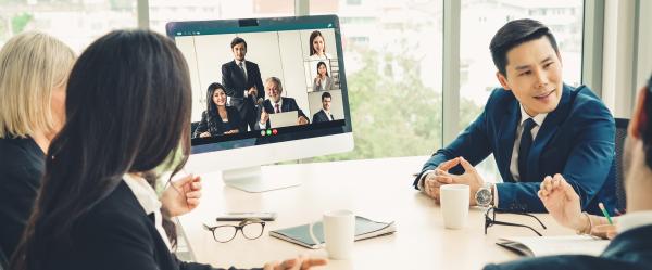 Hybrid meeting with some attendees in a room and others on-screen