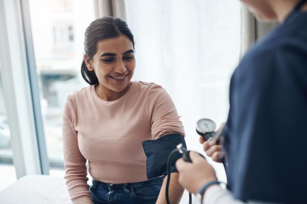 Woman sat having blood pressure checked