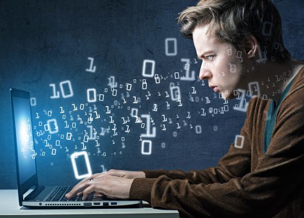 Man using laptop with superimposed 0 and 1 digits coming out of screen