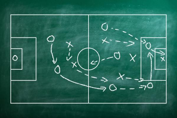 Football pitch with player strategy marked out on chalkboard 