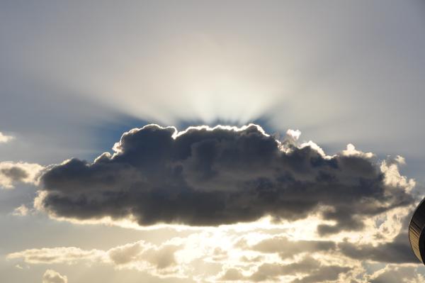 Dark cloud illuminated from behind by bright sunlight