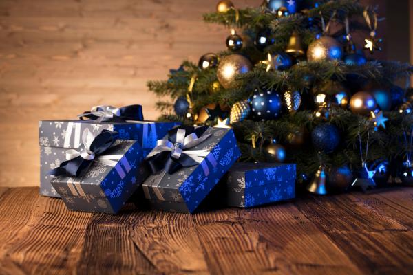 Wrapped presents under a decorated tree